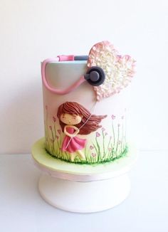 a cake decorated with a girl holding a pink umbrella