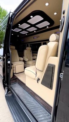 the interior of a luxury vehicle with its doors open