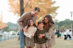 an older man and two young children posing for the camera