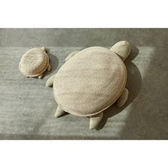 two sea turtle cushions on the ground