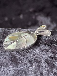 15% off Holidays Sale This vintage 950 fine silver pendant is a unique boho style piece that is sure to catch the eye. The pendant is in the shape of a leaf and features a stunning mother of pearl/abalone main stone in a range of beautiful multicolor hues. Crafted with sterling silver, this pendant is of the highest quality with a metal purity of 950. The pendant is perfect for those who love nature and beauty, as well as those who are inspired by bohemian style. This piece is in excellent condition and is sure to be a treasured addition to any jewelry collection. Dimensions: 2.5 inches high, 1.75 inches wide, .25 inches thick. In excellent condition. Thank You, Kevin Bohemian Silver Jewelry With Mother Of Pearl, Leaf Pendant, Abalone Shell, Fine Silver, The Eye, Boho Style, Bohemian Style, Mother Of Pearl, Silver Pendant