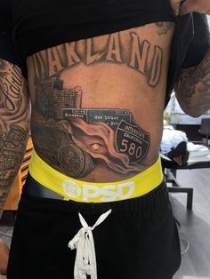 the back of a man's stomach with tattoos on his body and an image of a car