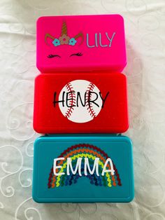 three personalized candy boxes on a bed