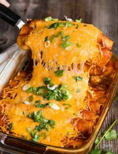 a casserole dish with cheese and vegetables being lifted from the casserole