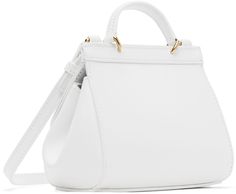 Buffed calfskin top handle bag in white. · Fixed carry handle · Adjustable and detachable crossbody strap · Pleat at sides · Logo plaque at magnetic press-stud flap · Satin lining · H5 x W7 x D3.25 Supplier color: White White Bag With Gold-tone Hardware And Round Handle, White Bags With Gold-tone Hardware And Round Handle, White Luxury Flap Bag With Double Handle, White Flap Bag With Detachable Top Handle, White Top Handle Flap Bag With Detachable Handle, White Top Handle Flap Bag With Detachable Strap, White Top Handle Flap Bag For Travel, White Flap Shoulder Bag With Detachable Handle, White Crossbody Flap Bag With Gold-tone Hardware