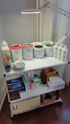 an image of a shelf that has some containers on it and other items sitting on top of it