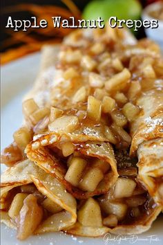 apple walnut crepes on a white plate with apples in the background and text overlay