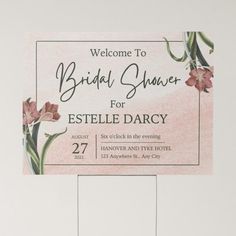 a welcome sign for a bridal shower with flowers on the front and back of it