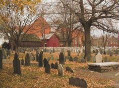 an old cemetery with many headstones and trees