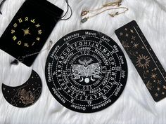 an assortment of items are laid out on a white furnishing with gold stars and zodiac signs