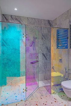 SH SpotLight Rainbow shower partition is a result of an iridescent glass filmThe shower area is lined with Banswara marble with red aventurine terrazzo flooring for the rest of the bathroomGuest Bathroom in parkHAUSdesigned by Kunaal @kyhaanSHarchives desidesign studiohaus KOY Iridescent Soap Dispenser, Iridescent Living Room, Irridescent Furniture, Iridescent Interior Design, Iridescent Tile Bathroom, Glass Shower Ideas, Iridescent Bathroom, Rainbow Terrazzo, Iridescent Interior