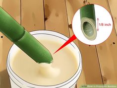 a green tube sticking out of the top of a white cup with milk in it