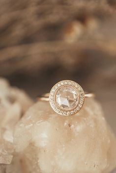 a diamond ring sitting on top of a rock