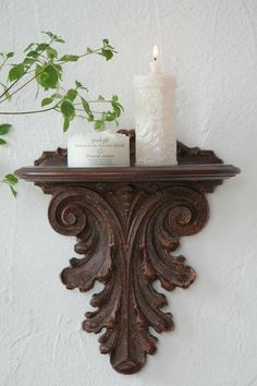 a candle is sitting on top of a shelf