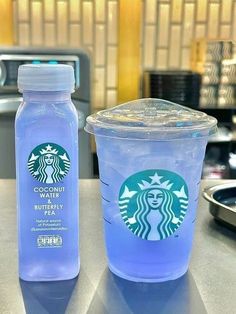 two plastic cups sitting next to each other on a counter