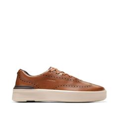 Discover the ultimate in casual comfort with the Men's GrandPr Crew Wingtip Oxford. A sport-inspired silhouette crafted in leather uppers delivers effortless style while the ultra lightweight design means comfort all day. Plus this sustainable style is designed with a minimum of 25% naturally derived or recycled content by weight and features our patented FlowerFoam sole. Size: Men 9.5.  Color: Brown.  Gender: male.  Age Group: adult. Casual Leather Golf Shoes With White Sole, Casual Low-top Golf Shoes With Perforations, Casual Leather Golf Shoes With Round Toe, Casual Leather Golf Shoes, Leather Moc Toe Sneakers For Streetwear, Modern Low-top Sneakers With Brogue Detailing, Brown Wingtip Sneakers With Perforations, Leather Lace-up Golf Shoes For Streetwear, Casual Golf Shoes With Rubber Sole And Round Toe