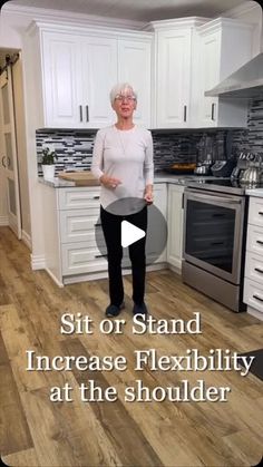 an older woman standing in a kitchen with the words sit or stand increase flexibility at the shoulder