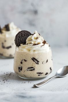 an oreo cookie and cream dessert in a small glass with a spoon on the side