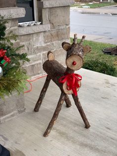 a wooden reindeer statue sitting on top of a porch