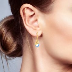 The swan is known around the world for its beauty, elegance, and grace. Inspired by the elegant swan, these earrings in Hug Me® collection are crafted entirely from sterling silver in a gold-tone. The design features a swan sleeping on an aquamarine blue heart-cut stone. These earrings will add color to your everyday style or dress up an evening look with this amazing swan design. You will find more adorable and creative designs in our Hug Me® collection.Carat Weight: 15 ctStone Size: 8*8 mmSton Elegant Hoop Earrings With Heart Charm For Weddings, Elegant Hoop Earrings With Heart Charm, Elegant Wedding Hoop Earrings With Heart Charm, Elegant Yellow Gold Hoop Earrings With Heart Charm, Elegant Teardrop Earrings With Heart Charm, Elegant Heart Earrings With Ear Wire, Elegant Yellow Gold Teardrop Heart Earrings, Elegant Heart-shaped Earrings With Lever Back, Elegant Teardrop Heart Charm Earrings