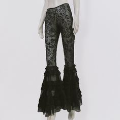 Black semi sheer flamenco pants with ruffles, embroidered with black mini beads vintage 80s Incredible flamenco style pants from the 80s. The black sheer pants have a flare cut, both tight and ultra flared, thanks to the addition of ruffles on the bottom of the legs. The pants are entirely embroidered with tone-on-tone mini black beads forming a delicate floral pattern. It fits like leggings. No composition label, but it is a synthetic and stretch fabric. The perfect party pants! Size indicated: 80s Pants, 70s Pants, Sheer Pants, Ruffle Leggings, Disco Pants, Festival Pants, Sequin Pants, Party Pants, Embroidered Pants