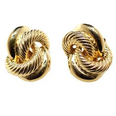 Interwoven textured gold hoops create these elegant classic clip on earrings.   1" Length Luxury Gold Timeless Clip-on Earrings, Classic 14k Gold Clip-on Earrings, Gold Plated Hoop Clip-on Earrings For Formal Events, Gold Hoop Clip-on Earrings For Formal Occasions, Elegant Gold Hoop Clip-on Earrings, Classic Round Gold-tone Clip-on Earrings, Formal Gold Plated Hoop Clip-on Earrings, Classic Gold-tone Round Clip-on Earrings, Elegant Gold Woven Earrings