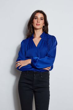 It's all in the details. Romantic & feminine, our smocked long sleeve shirt features a split tie neckline & pleated ruffle stand collar. With its long blouson sleeves & effortless fit, this style is a year-round essential. T-Tahari Long sleeve Airflow Blouse with Smocking Detail Runs true to size Model is 5'9" and wearing size S 100% Poly Georgette Dry Clean Only Imported Style #: THF47006 Long Sleeve Smocked Top For Work, Elegant Long Sleeve Smocked Top For Fall, Chic Long Sleeve Smocked Top For Work, Fitted Long Sleeve Smocked Top For Work, Long Sleeve Ruched Blouse For Date Night, Long Sleeve Blouse With Smocked Bodice For Work, Chic Long Sleeve Blouse With Smocked Bodice, Chic Long Sleeve Smocked Top With Gathered Sleeves, Long Sleeve Smocked Top For Workwear