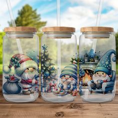 three glass jars with santa and snowmen on them