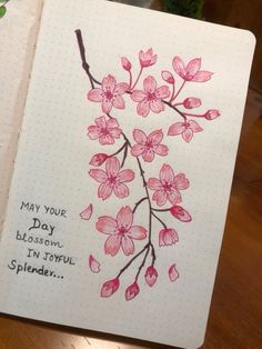 a notebook with pink flowers on it and the words may your day blossom in tokyo splended