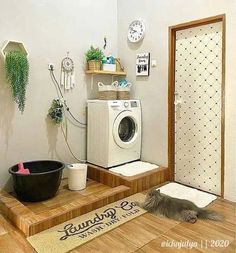 a laundry room with a washer and dryer on the floor next to it