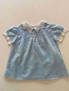 Vintage early 1950's baby girl dress. Light weight cotton batiste. So many sweet details of tiny pintucks, cutwork, embroidery and scalloped edges. Three-button closure in the back. Excellent vintage condition - very special!  Tad reads BML Hand Made. There is no size. Modern size 3-6 months is just an estimate. Please check measurements for an accurate fit. Questions are welcome! Dress was measured across the front side lying flat. underarm to underarm 11 1/2" length 15" shoulder 9" Batiste Dress, Heirloom Dresses, Dress With Embroidery, Cutwork Embroidery, Scalloped Edges, Cut Work, Pin Tucks, Girl Dress