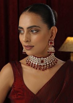 Make a striking statement with this Red Polki Choker set, featuring radiant red stones set in traditional Polki design and finished with a luxurious rose gold touch. The elegant choker design offers a contemporary twist on classic beauty, with the rose gold accents enhancing the deep red hues. Ideal for weddings, festive occasions, or any special event, this set brings together timeless sophistication and modern flair. Red Necklace With Elegant Design, Red Necklaces With Elegant Design, Luxury Red Jewelry For Festive Occasion, Luxury Red Festive Jewelry, Elegant Red Kundan Necklace For Wedding, Elegant Red Jewelry Sets For Festive Occasions, Festive Red Ruby Jewelry Set, Luxury Red Bridal Necklace For Celebration, Rose Gold Ruby Jewelry For Parties