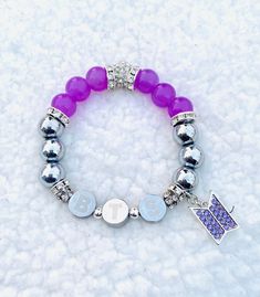 "Rep your Bangtan boys! BTS Genuine Stainless Steel and Hematite beaded bracelet with purple glass beads, crystal pavé and silver accents. Stainless letters are etched with \"BTS\".  Purple pavé BTS logo charm. Size: Approx 7\", stretches to fit." Kpop Style Silver Beaded Bracelets, Silver Beaded Bracelets Kpop Style For Gift, Silver Beaded Kpop Style Bracelets, Silver Beaded Kpop Bracelets As Gift, Bracelet Violet, Hematite Beads, Glass Beaded Bracelets, Purple Glass, Gorgeous Bracelet