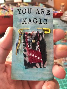 someone holding up a piece of fabric with the words you are magic on it