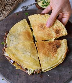 a person is cutting up some food on a plate with a knife and fork in it