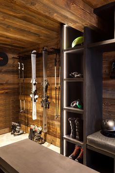 a room with wooden walls and shelves filled with skis