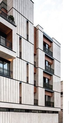 an apartment building with balconies on the second floor