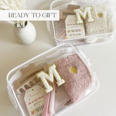 two plastic containers filled with personal items and the words ready to gift written on them