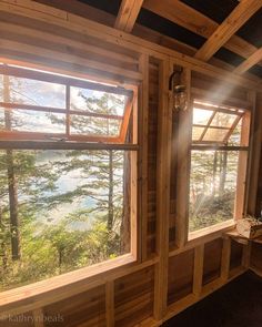 the sun shines through two windows in a cabin