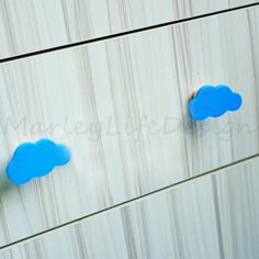 two blue cloud knobs on a white dresser