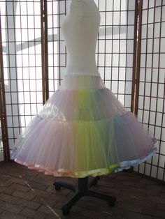 This listing is for a custom version of the pastel rainbow tulle petticoat shown in the photos. The waist area is as fitted as possible so that it just fits over the largest part of the body. The waistband is .5 (1,25cm) wide elastic covered with white polyester satin for comfort. The waist area has 2 layers of tulle and is 4 (10cm) long in the photo but can be customized to be shorter or longer, depending on your needs -- just let me know how long the fitted portion needs to be for your dres... Fitted Organza Petticoat For Spring, Fitted Spring Organza Petticoat, Spring Fitted Organza Petticoat, Fitted Multicolor Tulle Dress, Fitted Tulle Petticoat For Spring, Cute Rainbow Tulle Dress, Rainbow Petticoat Wedding, Spring Ballet Tulle Petticoat, Tulle Rainbow