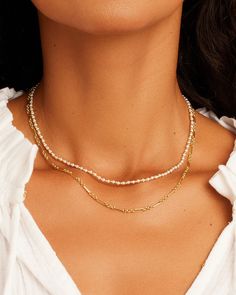 Description The Poppy Pearl Necklace Set includes two gorgeous gold-plated necklaces perfect for creating a layered look. The set allows you to play with necklace styling effortlessly, enabling you to customize your look with ease. Layer the two necklaces for a fun, beautiful look, or wear separately or with other necklaces you love. Product Details Poppy Pearl Necklace Total length 16" Hinge closure measures 5/16" Pearlized beads and gold beads measure 1/16" Available in 18k gold plated brass A Trendy Double Strand Figaro Chain Necklaces, Trendy Double Strand Figaro Chain Jewelry, Trendy Double Strand Figaro Chain Necklace, Elegant Figaro Chain Layered Necklace, Yellow Gold Double Strand Pearl Necklace, Yellow Gold Double Strand Pearl Chain Necklace, Classic Double Strand Layered Necklace, Double Strand Yellow Gold Pearl Chain Necklace, Double Strand Figaro Chain Necklace For Layering