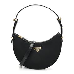 This is an authentic PRADA Re-Nylon Spazzolato Arque Shoulder Bag in Black. This is a chic Prada handbag that is beautifully crafted of black re-nylon with brushed calfskin leather sides and trim. The crossbody bag features a matching leather shoulder strap and an optional adjustable long shoulder strap, with gold hardware. The zip top opens to a black leather interior with a patch pocket. Prada Handbag, Shoulder Bag Black, Prada Handbags, Leather Interior, Zip Top, Gold Hardware, Patch Pocket, Calf Skin, Prada