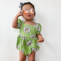 The green daisy romper is the perfect vintage-inspired piece for your little girl. Featuring a cool daisy print on a cheery green background, a square neckline, and cute puff sleeves, your little one will be irresistibly cute in this nostalgic romper. Not only will they look absolutely cute in this timeless piece, they will be so comfortable since it's made from a stretchy cotton spandex blend material. What's better than sweet vintage style with modern comfort for a little one?