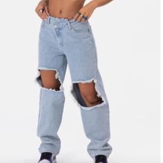 Denim Done Right. High-Waisted Boyfriend Jeans With Wrap-Waist Button And Zip Closure, Distressed Detail In The Front, Belt Loops, And A 5-Pocket Design. Fabric / Material: Cotton Item Care: Hand Wash Color: Light Blue Denim Size Large, New With Tags Trendy Baggy Ripped Bottoms, Blue Baggy Ripped Bottoms, Trendy Ripped Blue Pants, High Waist Ripped Cotton Pants, Ripped High Waist Cotton Pants, Trendy Relaxed Fit Ripped Bottoms, High Waist Relaxed Fit Ripped Pants, Ripped High Waist Relaxed Fit Pants, High Rise Ripped Baggy Bottoms