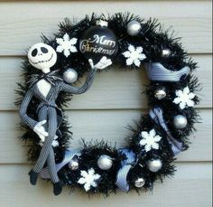 a wreath decorated with black and white decorations