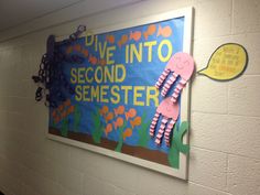 there is a sign on the wall that says dive into second semester and it's written