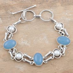 Luminous pearls mingle with the mystique of blue chalcedony in a beautiful bracelet. From Bhavesh, the design showcases the gems in sterling silver links. .925 Sterling silver Fine Silver Jewelry With Chalcedony, Fine Silver Chalcedony Jewelry, Luxury Bohemian Chalcedony Jewelry, Unique Blue Chalcedony Jewelry, Elegant Nickel-free Chalcedony Jewelry, Buy Pearls, Silver Link Bracelet, Freshwater Cultured Pearls, Blue Chalcedony