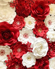 red and white paper flowers are arranged together