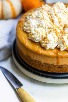 a cheesecake topped with whipped cream and caramel